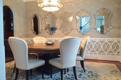 Example of a mid-sized trendy medium tone wood floor and brown floor enclosed dining room design in Other with gray walls