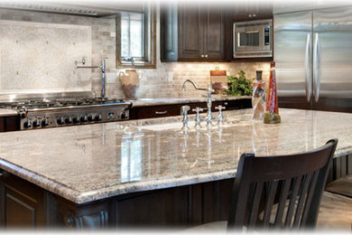 Inspiration for a medium tone wood floor kitchen remodel in Toronto with dark wood cabinets, granite countertops, gray backsplash, stainless steel appliances and an island