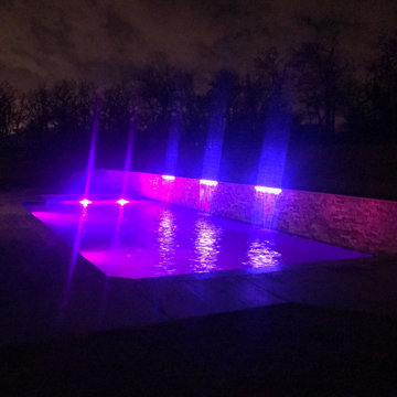 Custom pool with elevated back wall and LED Waterfalls