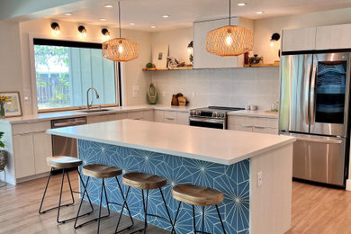 Inspiration for a coastal kitchen in Hawaii with flat-panel cabinets and white cabinets.