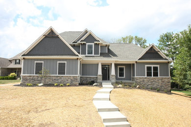 Mid-sized transitional gray two-story mixed siding house exterior idea in Indianapolis with a shingle roof
