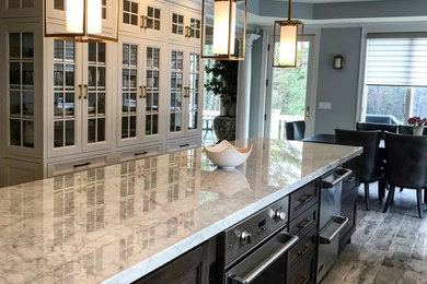 Eat-in kitchen - large modern l-shaped ceramic tile and gray floor eat-in kitchen idea in Boston with an undermount sink, recessed-panel cabinets, white cabinets, marble countertops, white backsplash, marble backsplash, stainless steel appliances, an island and yellow countertops