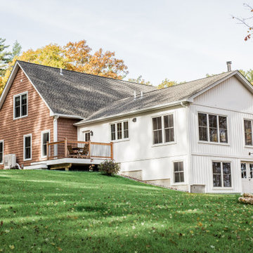 White Board and Batten Farmhouse with attached garage with shakes