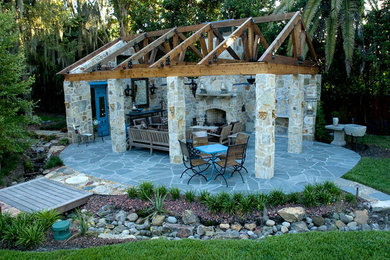 Inspiration for a large country backyard stone patio remodel in Tampa with a fireplace and a gazebo