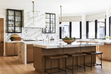 Example of a transitional u-shaped light wood floor kitchen pantry design in San Diego with marble countertops, multicolored backsplash, marble backsplash, two islands and white countertops