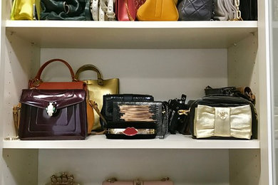 Mid-sized trendy women's walk-in closet photo in Los Angeles