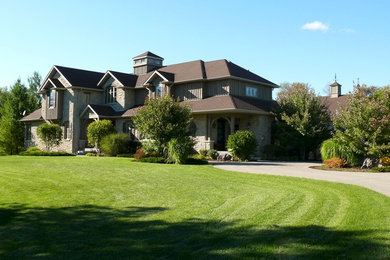 Large transitional two-story wood exterior home photo in Toronto