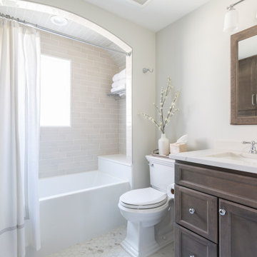 Traditional Hall Bath with Wood Vanity & Shower Arch Details