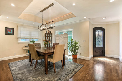 Inspiration for a transitional medium tone wood floor and brown floor enclosed dining room remodel in San Francisco with beige walls and no fireplace