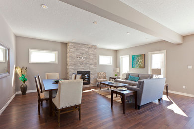 Inspiration for a large timeless formal and open concept dark wood floor and brown floor living room remodel in Toronto with beige walls, a standard fireplace, a stone fireplace and no tv