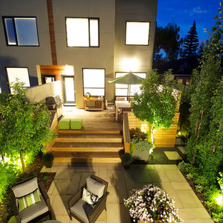 This is an example of a small contemporary backyard patio in Calgary with a fire feature, concrete pavers and no cover.