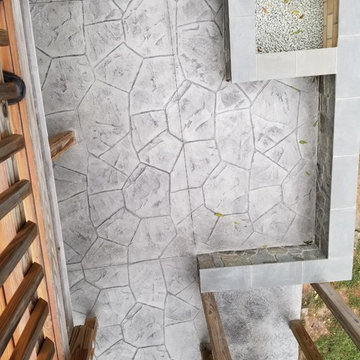 C-Stamped concrete patio with a wall