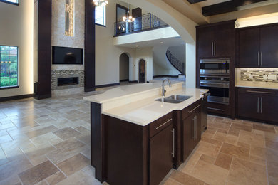 Eat-in kitchen - huge transitional u-shaped eat-in kitchen idea in Orlando with a double-bowl sink, flat-panel cabinets, multicolored backsplash, stainless steel appliances and an island