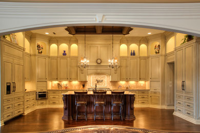 Open concept kitchen - huge traditional u-shaped dark wood floor open concept kitchen idea in Other with an island, distressed cabinets, granite countertops, beige backsplash, stone tile backsplash, stainless steel appliances, a farmhouse sink and raised-panel cabinets