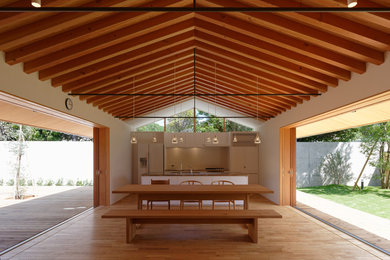 Inspiration for a contemporary light wood floor and brown floor great room remodel in Kyoto with white walls
