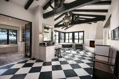 Example of a large transitional master black and white tile and stone slab marble floor and black floor freestanding bathtub design in Los Angeles with recessed-panel cabinets, white cabinets, white walls, marble countertops and black countertops