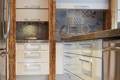 Inspiration for a modern eat-in kitchen remodel in Montreal with flat-panel cabinets, white cabinets, quartz countertops and an island