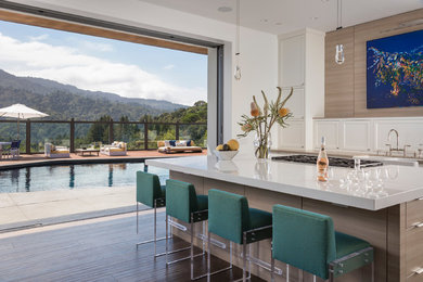 Mid-sized trendy dark wood floor open concept kitchen photo in San Francisco with shaker cabinets, white cabinets, paneled appliances and an island