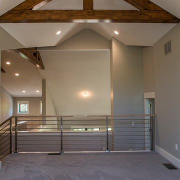 Loft with Exposed Beams & Steel Railing