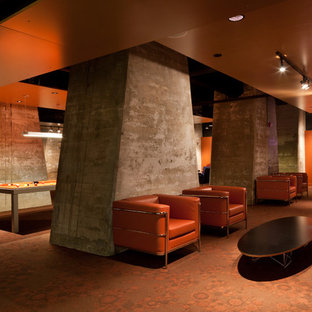 Design ideas for an expansive industrial fully buried basement in Baltimore with orange walls, carpet, no fireplace and orange floors.