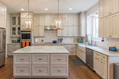 Mid-sized 1950s u-shaped enclosed kitchen photo in Dallas with recessed-panel cabinets, white cabinets, quartzite countertops, white backsplash, stainless steel appliances, an island and white countertops