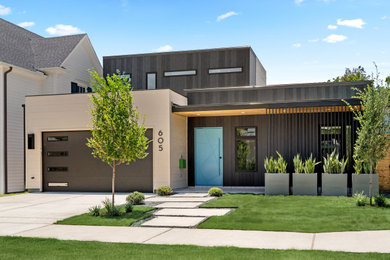 Mid-sized 1960s black two-story metal and board and batten exterior home photo in Houston with a mixed material roof and a black roof