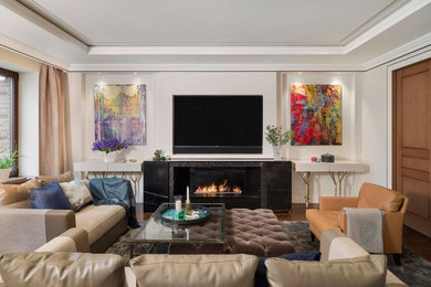Trendy medium tone wood floor and brown floor living room photo in London with white walls and a wall-mounted tv
