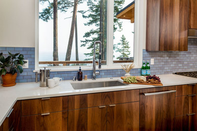 Inspiration for a mid-sized contemporary l-shaped light wood floor, brown floor and vaulted ceiling open concept kitchen remodel in Seattle with an undermount sink, flat-panel cabinets, dark wood cabinets, quartz countertops, blue backsplash, porcelain backsplash, stainless steel appliances, an island and white countertops