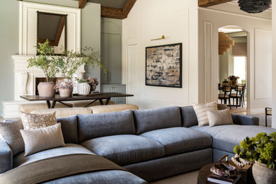 Inspiration for a huge transitional enclosed porcelain tile, beige floor, vaulted ceiling and wall paneling family room remodel in Phoenix with beige walls, a standard fireplace, a stone fireplace and a wall-mounted tv
