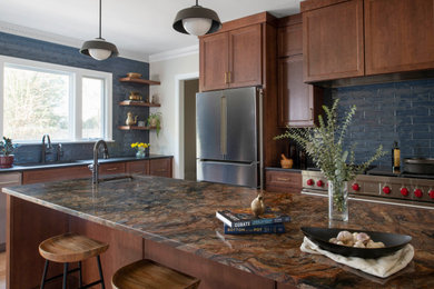 Example of a trendy kitchen design in Raleigh with medium tone wood cabinets, blue backsplash, porcelain backsplash, stainless steel appliances and an island