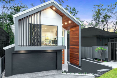 This is an example of a large and white contemporary two floor detached house in Brisbane.