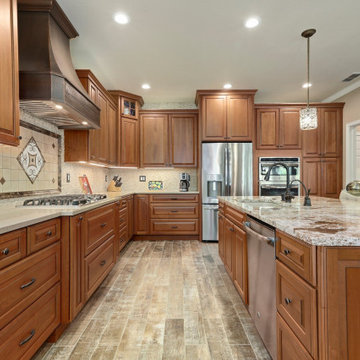 VARYING HEIGHT CABINETS LEND INTEREST TO A LARGE KITCHEN