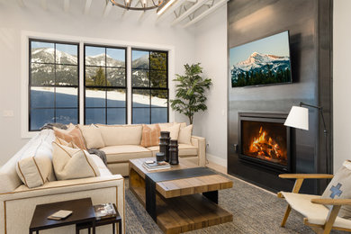 Inspiration for a modern exposed beam living room remodel with white walls, a standard fireplace and a metal fireplace