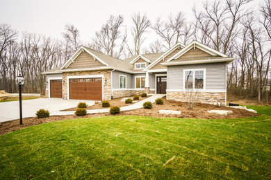 Inspiration for a timeless gray one-story mixed siding house exterior remodel in Chicago