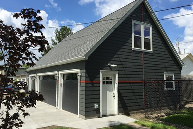 Inspiration for a large modern detached four-car garage workshop remodel in Minneapolis