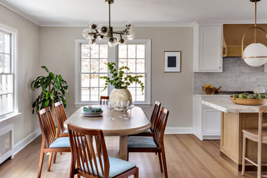 Example of a mid-sized transitional light wood floor and beige floor kitchen/dining room combo design in New York with beige walls