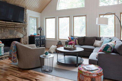 Living room - large transitional open concept medium tone wood floor living room idea in Atlanta with white walls, a standard fireplace, a stone fireplace and a wall-mounted tv
