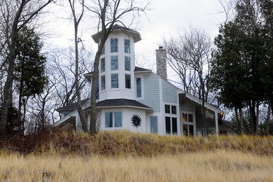 Mid-sized beach style gray two-story exterior home photo in Other with a shingle roof