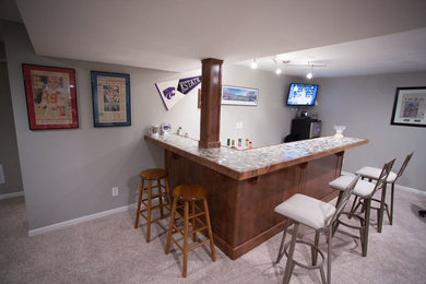 Inspiration for a mid-sized transitional look-out carpeted basement remodel in Kansas City with gray walls