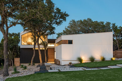 Inspiration for a contemporary white two-story exterior home remodel in Austin with a shed roof