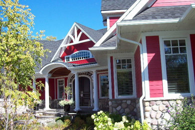 Large craftsman red one-story mixed siding exterior home idea in Toronto with a clipped gable roof