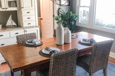 Mid-sized beach style medium tone wood floor kitchen/dining room combo photo in Milwaukee with gray walls