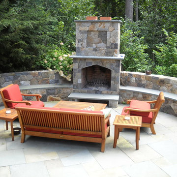 Outdoor fireplace with stone sitting bench