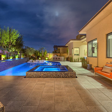 Contemporary Backyard Pool with Tiled Water Feature, Rim Flow Spa, & Fire Pit