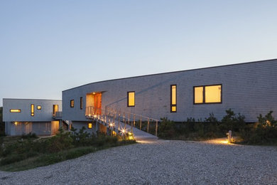 Example of a trendy gray two-story wood exterior home design in Boston