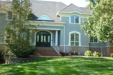 Large gray two-story exterior home photo in Other