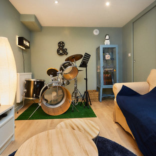 Small urban enclosed laminate floor and beige floor home theater photo in Dijon with green walls