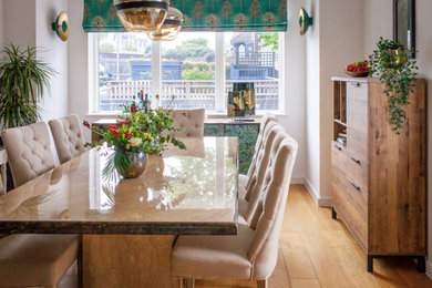 This is an example of a medium sized eclectic kitchen/dining room in London with white walls, dark hardwood flooring, no fireplace and beige floors.