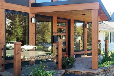 Large craftsman brown two-story wood exterior home idea in Calgary with a metal roof