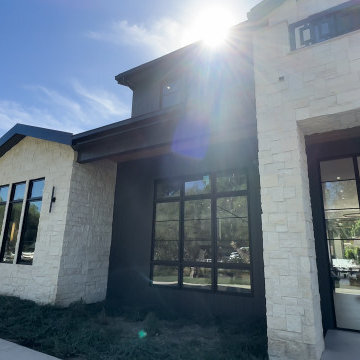 Front Elevation with Stone, Dark Siding and Deep Roof Overhangs - Woodland Hills